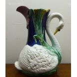 A majolica jug, fashioned as a swan amongst reeds