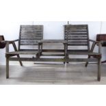 A weathered teak (one piece) duo combination two person bench, incorporating a central table with