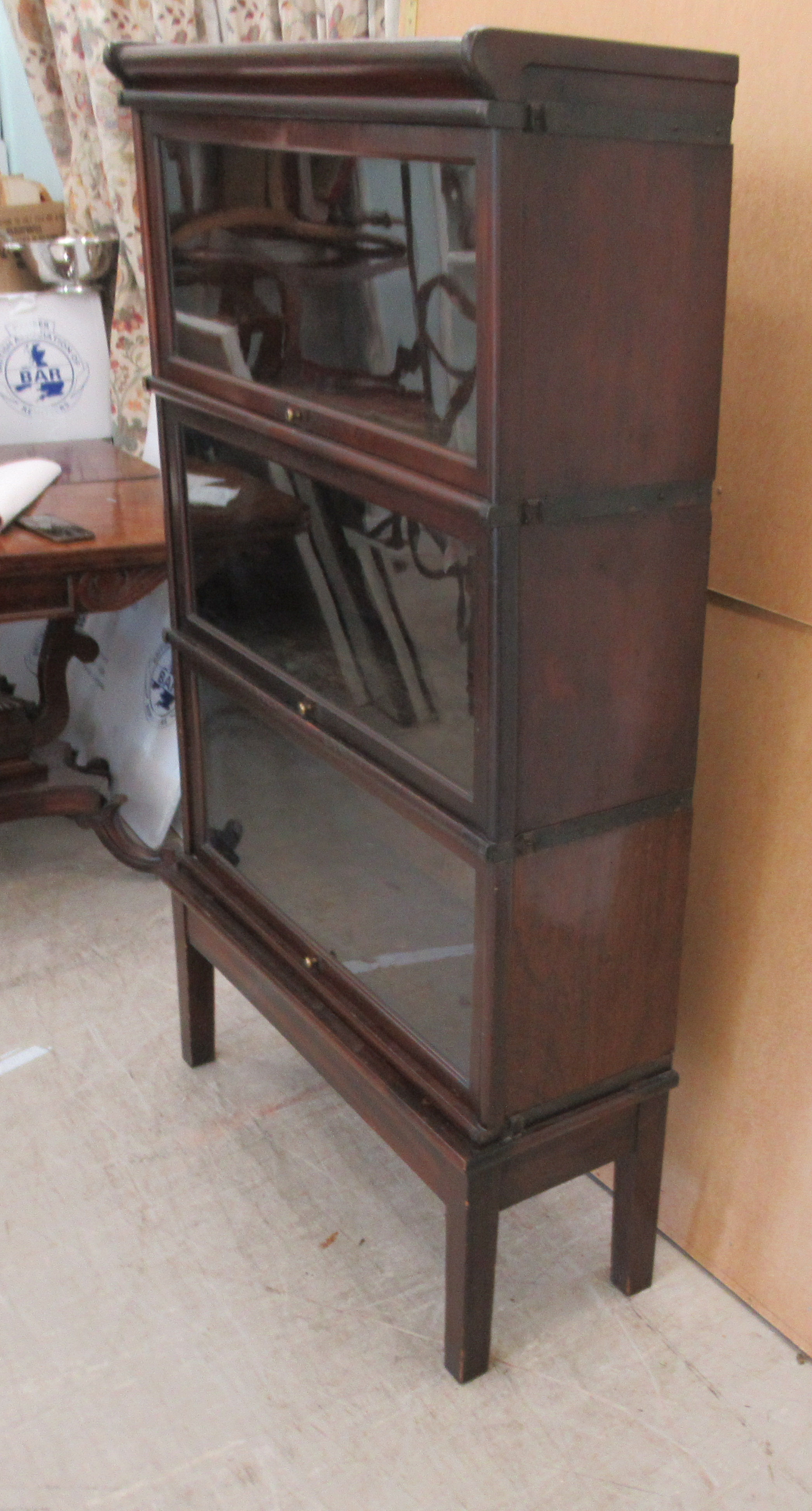 An early 20thC Globe Wernicke mahogany and glazed three section bookcase on stand, raised on - Image 2 of 5