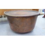 An early 20thC copper lidded, twin handled cooking pot  13"h  23"dia