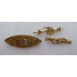 Three gold brooches, viz. one 15ct, shaped as a flower, set with pearls; another 15ct, in an
