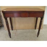 A George III mahogany bow front tea table, the rotating foldover top raised on ring turned,