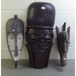 Three carved wooden tribal masks  largest 28"h