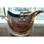 A late 19thC copper helmet design coal scuttle with a reeded swing handle