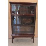 An early 20thC Globe Wernicke mahogany and glazed three section bookcase on stand, raised on