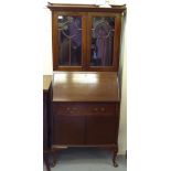 An Arts & Crafts string inlaid mahogany bureau bookcase with a pair of glazed doors, over a fall