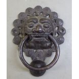 Modern door furniture, a cast iron door knocker with a ring handle and Dog of Fo mask ornament  8"