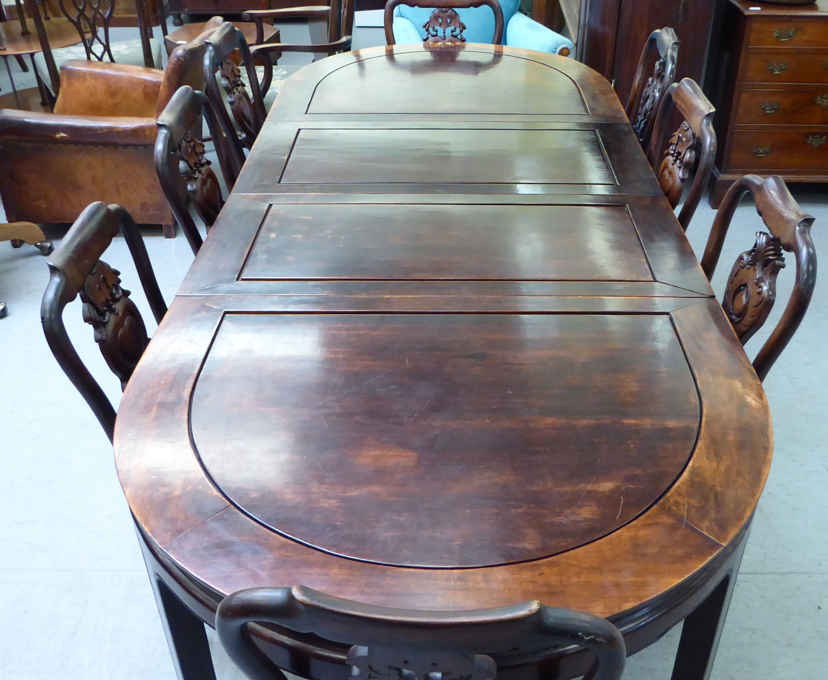 A modern Chinese mahogany dining table, raised on square legs and spade feet  30"h  60"dia with - Image 2 of 3