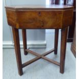 A George III mahogany sewing table with an octagonal hinged lid, raised on square legs  22"h  19"w