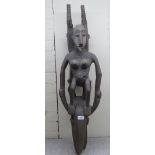 A carved wooden tribal figure  40"h