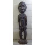 A carved wooden tribal figure  59"h