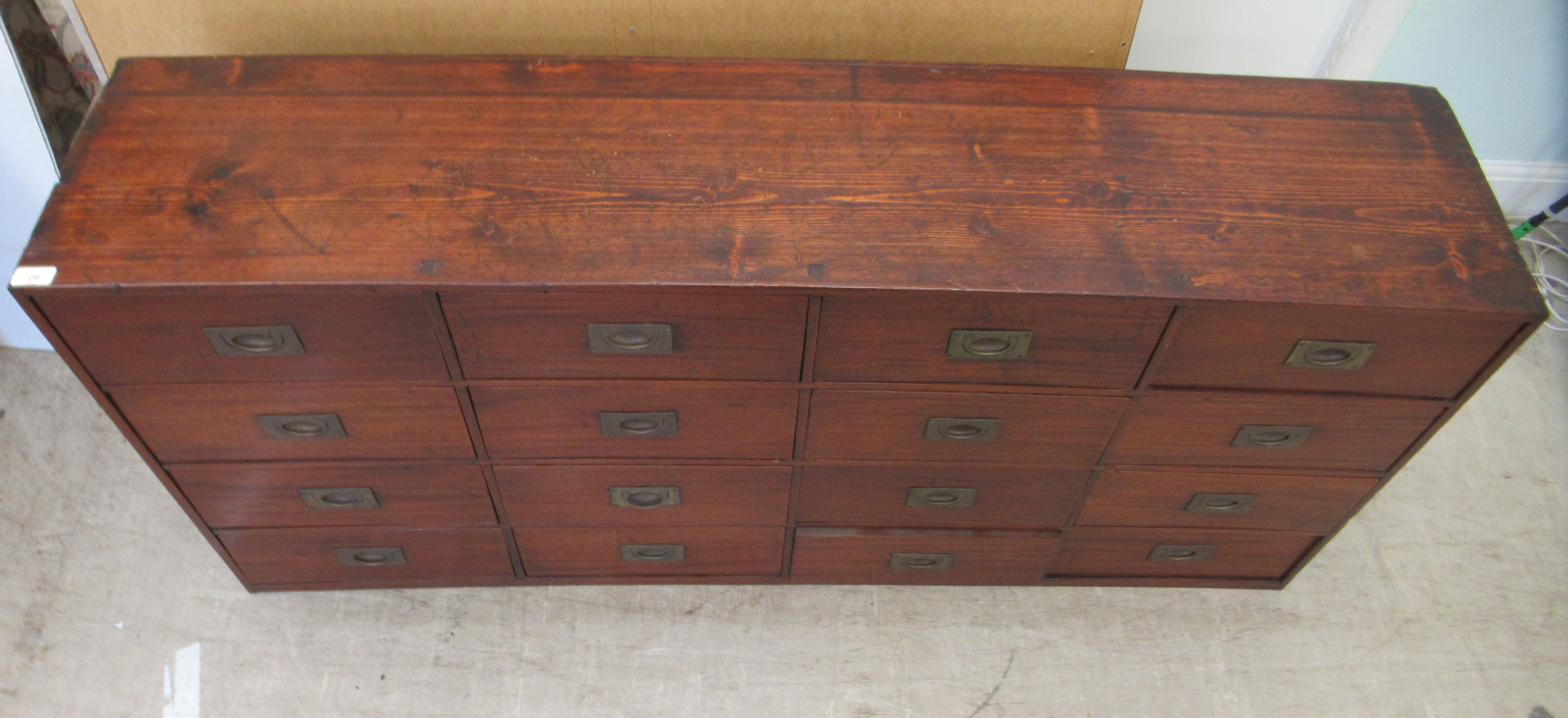 An early 20thC Chinese stained pine sixteen drawer cabinet, on a plinth  30"h  63"w - Image 2 of 5