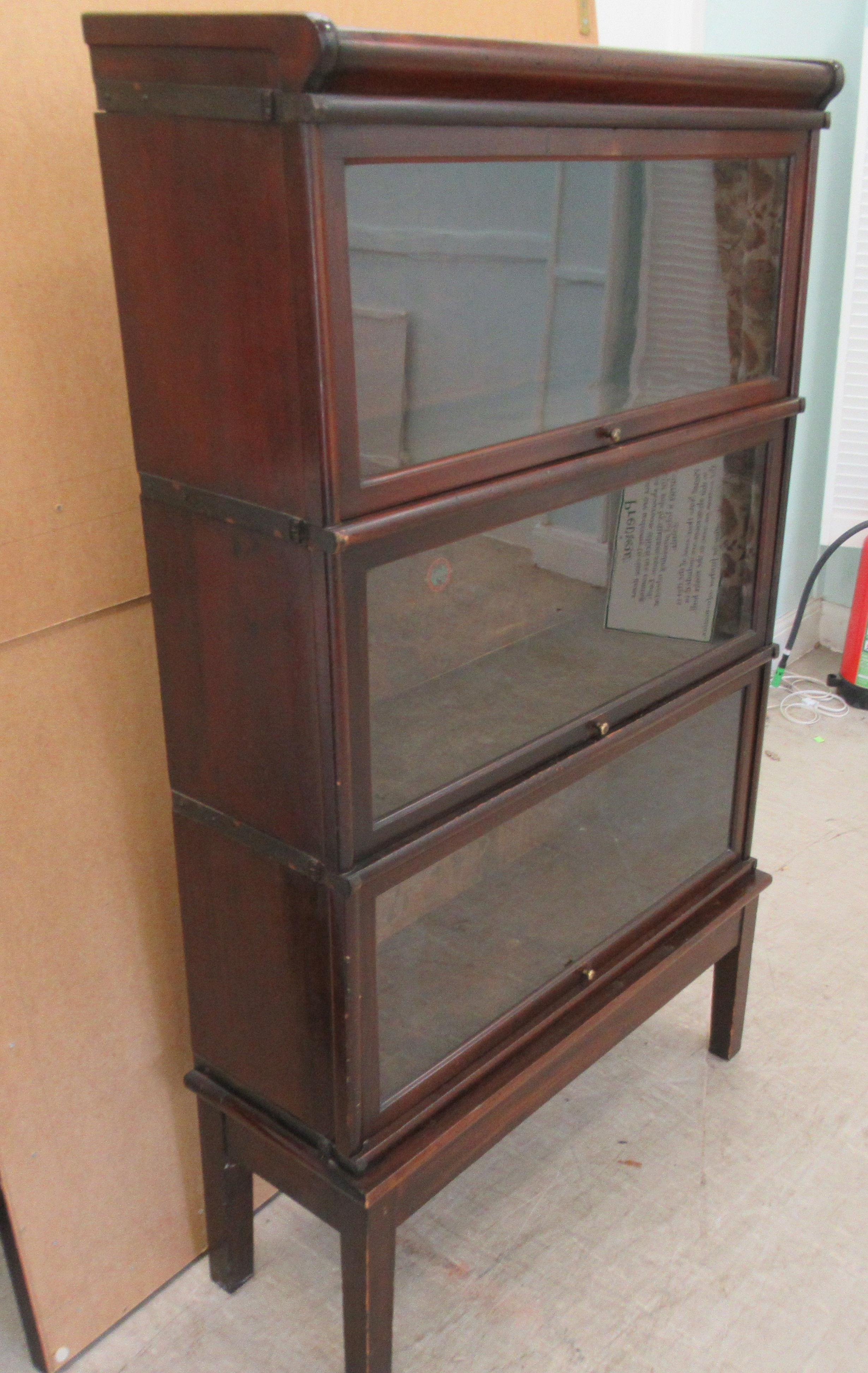 An early 20thC Globe Wernicke mahogany and glazed three section bookcase on stand, raised on - Image 3 of 5