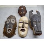 Four carved wooden tribal masks  largest 21"h