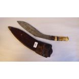 A late 19thC kukri, on a bone handle and curved blade  14"L with a hide sheath