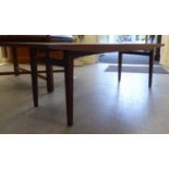 A Gordon Russell teak coffee table, raised on square, tapered legs  15"h  49"w