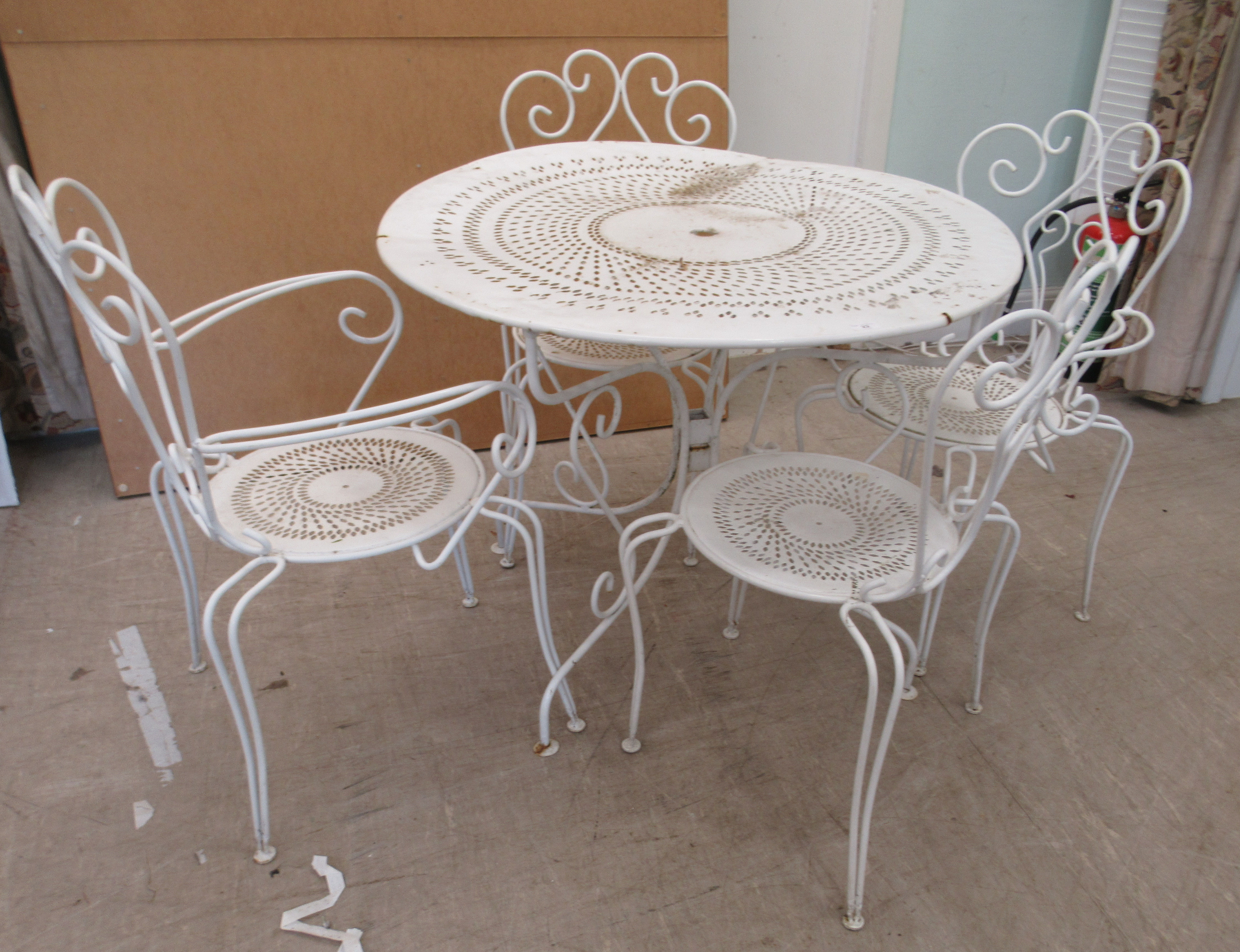 A 20thC white painted cast metal three part patio table  30"h  37"dia; and a matching set of four