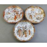 Three similar 20thC Japanese porcelain charges, decorated with garden scene  largest 15"dia