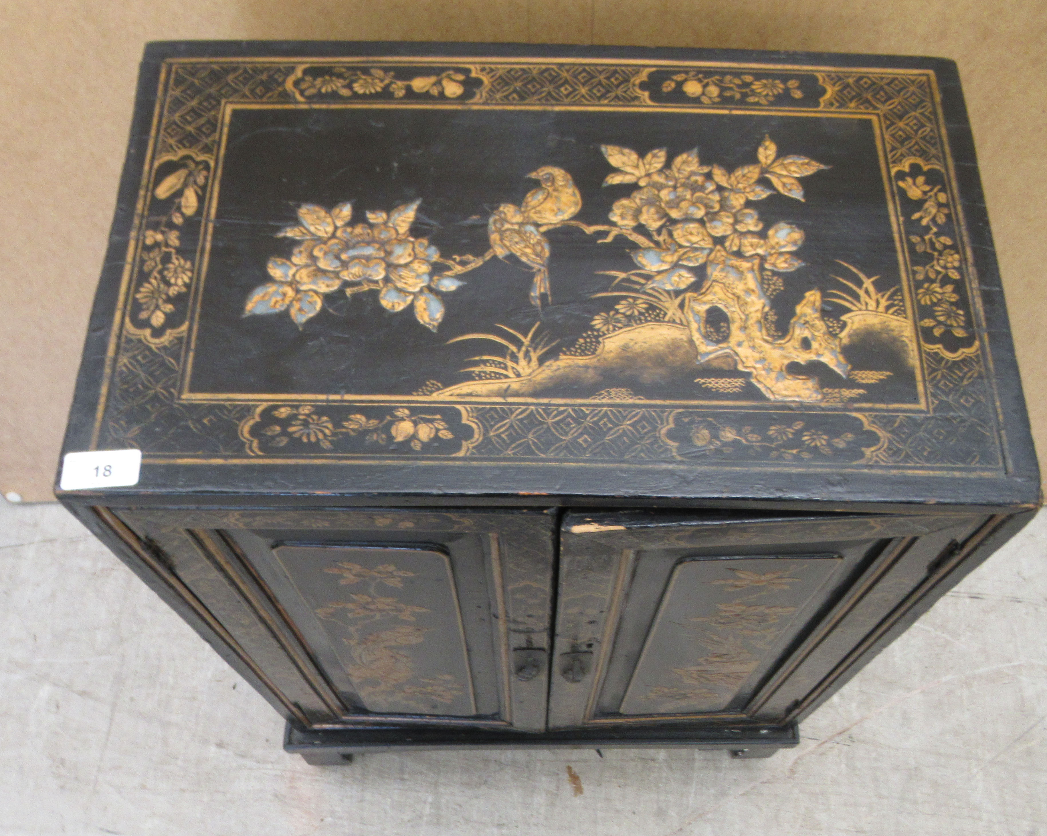 A 20thC Japanese black lacquered low cabinet on stand, decorated with birds and foliage  32"h  21"w - Image 2 of 5