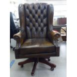 A Brights of Nettlebed adjustable wingback study desk chair, having level, enclosed arms, part