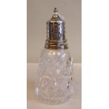 A star and slice cut crystal caster with a silver collar and decoratively pierced domed cover and