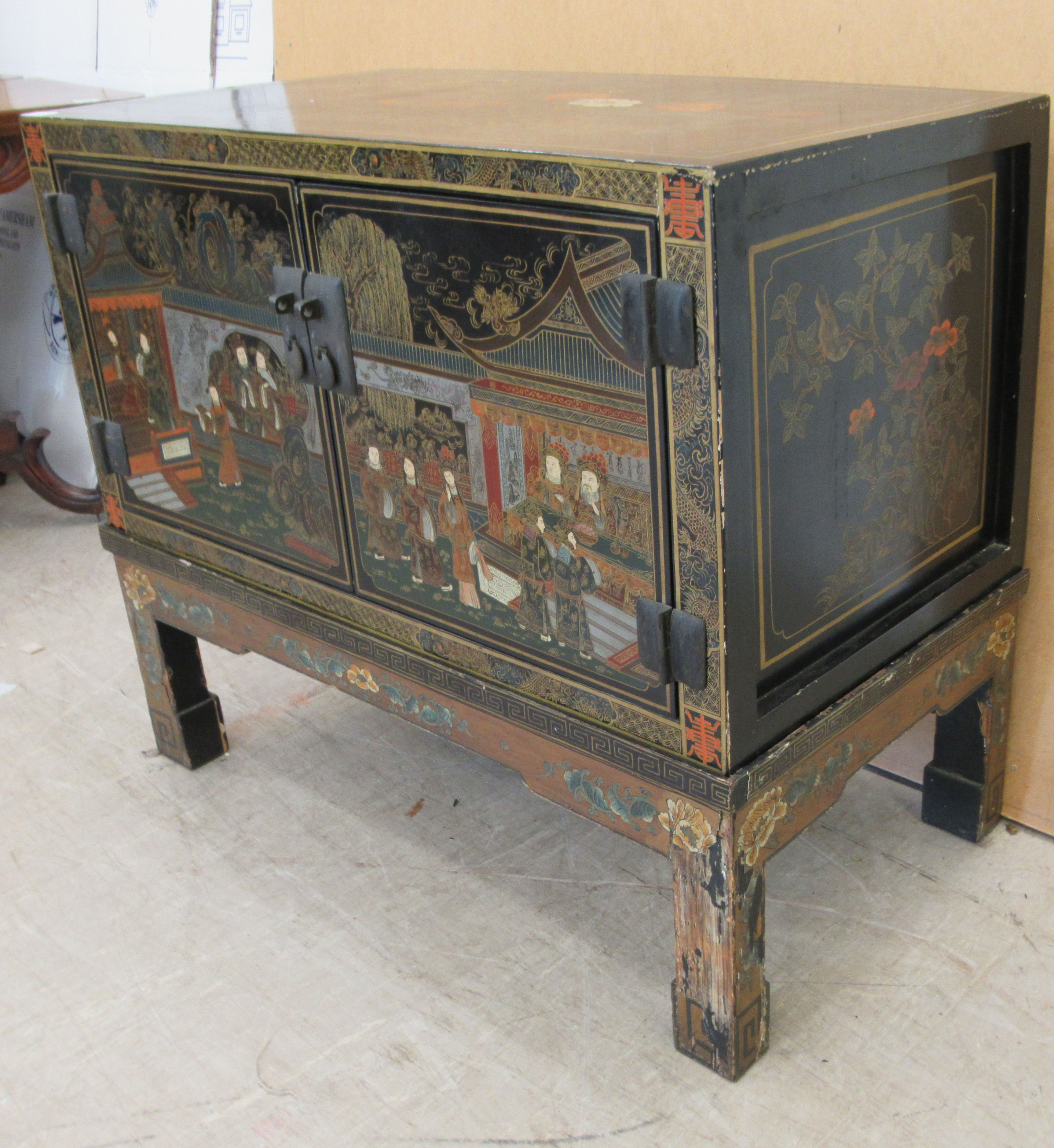 A 20thC Japanese black lacquered low cabinet on stand with two doors, decorated with traditional - Image 3 of 6