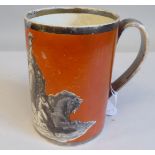 A 19thC Nelson commemorative pottery mug, transfer decorated in monochrome, on an orange ground,