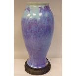 A Chinese Junyao streaky blue and green glazed pottery vase of waisted baluster form with a rolled