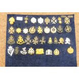 Over thirty military cap badges and other insignia, some copies: to include The County of London