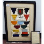 A display of Great War 36th (Ulster) Division military cloth flashes  13" x 19" framed with a