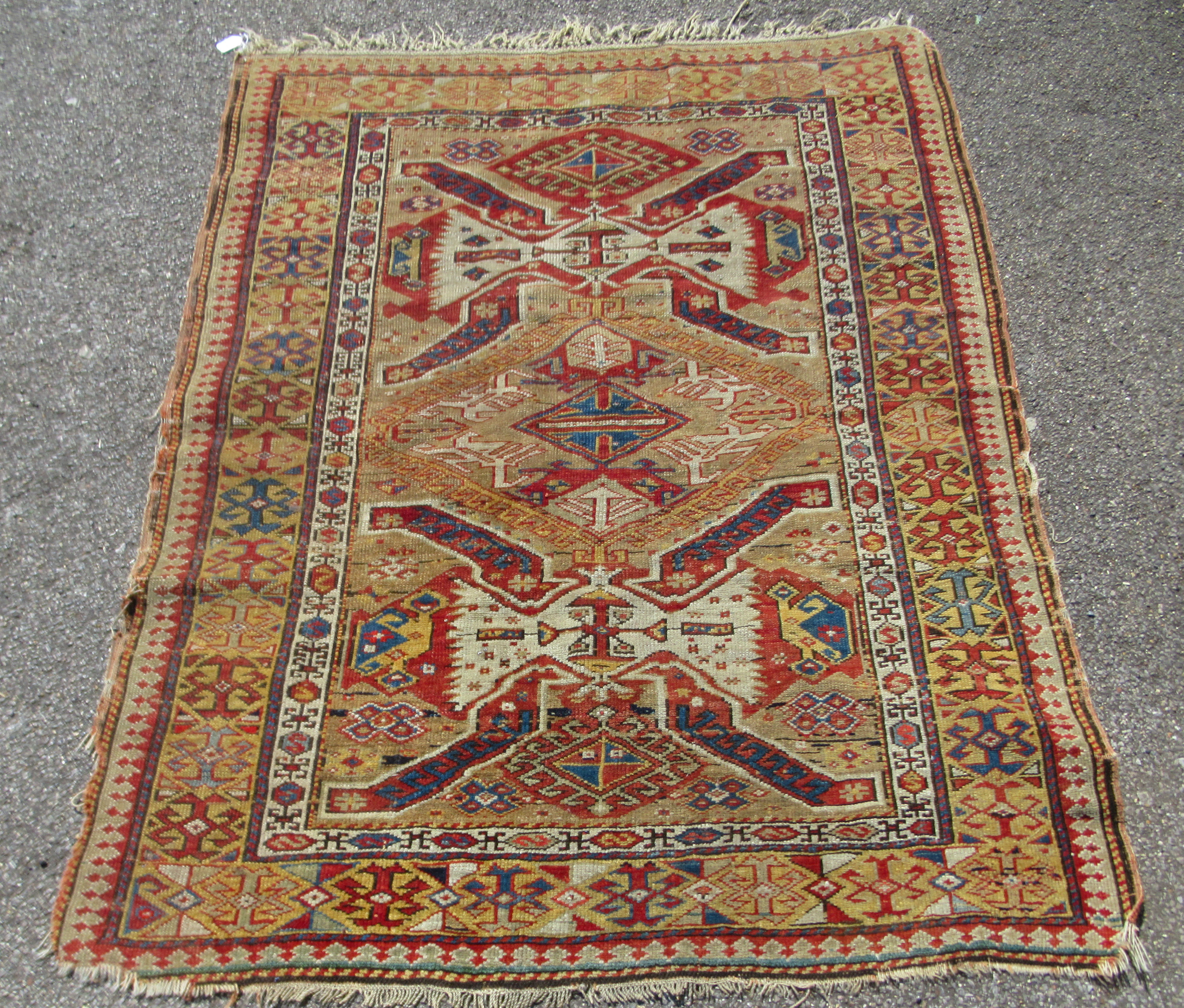 A Turkish rug, having a sunburst design within broad borders  60" x 47"