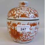 An early/mid 20thC Chinese porcelain bulbous bowl and cover, decorated in burnt orange with Shou