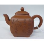 A Chinese Zisha teapot of square, bulbous form with a stubby S-shape spout, loop handle and lid,