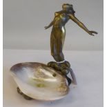 A late 19thC cast brass figure, a dancing nymph, beside an irregularly shaped shell pool  8"h