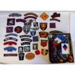 A miscellaneous collection of mainly military embroidered uniform badges, some copies: to include