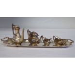 A four piece silver miniature demi-reeded tea set and oval tray  London 1975
