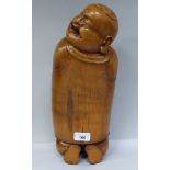 A Chinese carved and polished bamboo pillow, fashioned as a smiling, robed man  15"h