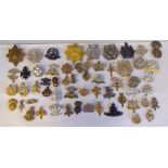 Approx. fifty military cap badges and other insignia, some copies: to include Royal Guernsey;