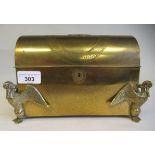 An early 20thC lacquered brass desktop stationery box with a domed lid and subdivided interior and