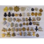 Approx. fifty military cap badges and other insignia, some copies: to include Connaught Rangers;