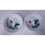 A pair of Chinese porcelain footed dishes, decorated in famille rose with a setting sun over the sea