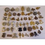Approx. fifty military cap badges and other insignia, some copies: to include The Lincolnshire;