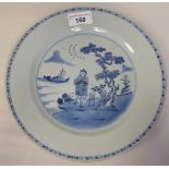 A Chinese porcelain plate, decorated in blue and white with a standing figure and a small boat  9.