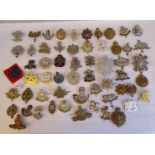 Approx. fifty military cap badges and other insignia, some copies: to include The Tank Corps; Army