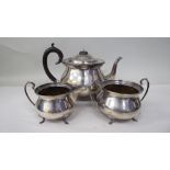 A three piece silver tea set of cauldron form, comprising a teapot with an S-shape spout,