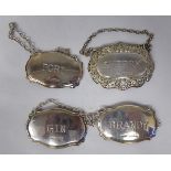 A set of three silver decanter labels, on chains, for Gin, Port and Brandy and another,