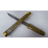 A Japanese embossed and chased brass dagger, the blade 6"L in a conforming sheath with a