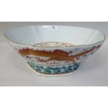 A Chinese porcelain wavy edge, panelled bowl on a deep footrim, decorated in famille rose with