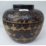A Chinese brown glazed pottery jar of shouldered bulbous form, decorated with friezes of stylised