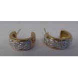 A pair of 9ct gold C-shape diamond set earrings